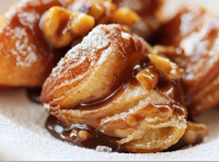 Biscuit Beignets with Praline Sauce | Just A Pinch Recipes image