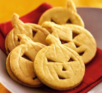 Orange pumpkin face cookies recipe | BBC Good Food image