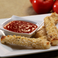 Baked mozzarella sticks with spicy tomato dipping sauce ... image