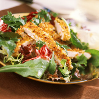 Sliced Lemon-Pistachio Chicken Over Greens Recipe | MyRecipes image