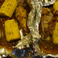 Foiled BBQ Chicken with Corn on the Cob and Pinto Beans ... image