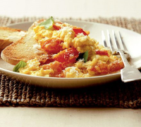 Tomato, basil & Parmesan scrambled eggs recipe | BBC Good Food image