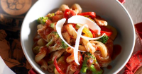 Chicken and vegetable pasta tossed with a tomato sauce ... image