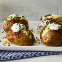 Baked Potatoes on the Grill Recipe - EatingWell image