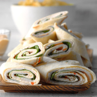 Spinach and Turkey Pinwheels Recipe: How to Make It - Taste of Home: Find Recipes, Appetizers, Desserts, Holiday Recipes & Healthy Cooking Tips image