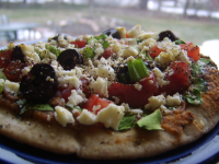 Pita Pizzas With Hummus, Spinach, Olives, Tomatoes ... image