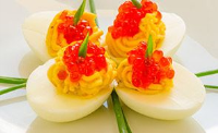 Deviled Eggs with Salmon Caviar and Roasted Garlic ... image