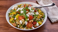 Herbed pearl couscous with cherry tomatoes and goat cheese image