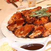 Rosemary-Scented Pork Loin Stuffed With Roasted Garlic ... image