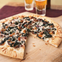Winter Greens, Asiago, and Anchovy Pizza Recipe | MyRecipes image