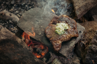 Steak On a Hot Rock with Wild Herb Butter Recipe | Epicurious image