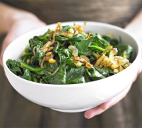 Spinach with onions & pine nuts recipe | BBC Good Food image