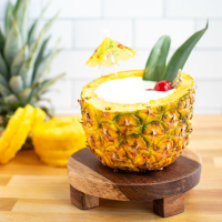Piña Colada in a Pineapple Recipe | EatingWell image