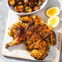 Chicken Under a Brick with Herb-Roasted Potatoes | America ... image