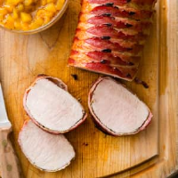 Bacon-Wrapped Pork Roast with Peach Sauce | Cook's Co… image
